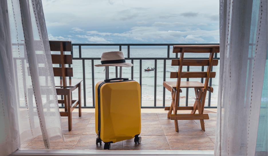 Gezonde vakantie reizen zonder bedwantsen, bagage op balkon uitzicht op zee